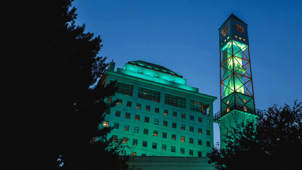 The Civic Centre clock tower lit up yellow and teal.